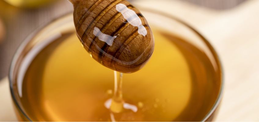 honey pouring into glass